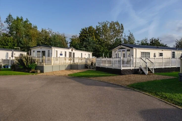 Woodland setting surrounding lodge plots at Silverhill Holiday Park